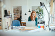 © Geber86 - Young female designer working on laptop in office