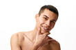 © master1305 - Handsome smiling young man with clear, spotless shaved face standing shirtless against white studio background. Concept of male beauty, skin care, spa, cosmetology, men's health
