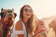 happy smiling young woman with camel in desert 