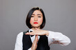Restaurant serious asian waitress dressed in uniform showing timeout symbol with palms portrait. Catering service woman worker making interruption gesture and looking at camera