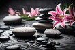 Lily and spa stones in zen garden. Stack of spa  stones with pink flowers