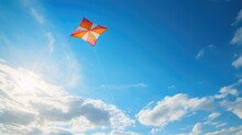 A Colorful Kite Flying High In A Bright Blue Sky