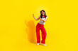 © deagreez - Full length photo of cute pretty woman dressed white t-shirt headphones having fun discotheque empty space isolated yellow color background