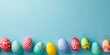 A line of colorful, patterned Easter eggs on a pale blue background with space on the right. web banner design