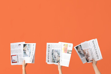 Wall Mural - Women with newspapers on orange background