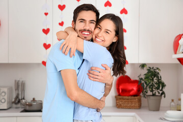 Poster - Happy young couple hugging in kitchen on Valentine's Day