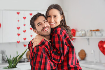 Canvas Print - Happy young couple hugging in kitchen on Valentine's Day