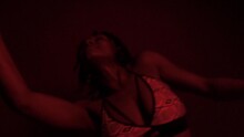 Slow Motion Of Black Woman Dancing With Vibrant Rythm Under Red Light 