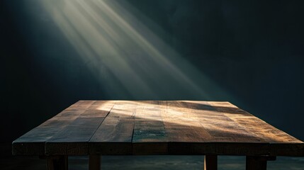 Poster -  a wooden table with a beam of light coming out of the top of it on a dark background with a spot of light coming from the top of the table.