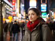 © MAX AI - A young woman standing on a bustling city street at night, the city lights reflecting in her thoughtful eyes. She appears contemplative. Generative AI
