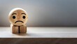 A wooden toy with sad face alone concept of loneliness and depression, unrequited love, parting or divorce