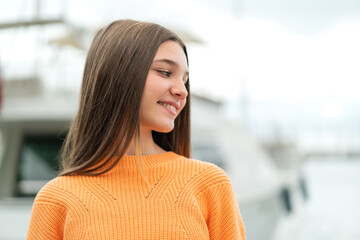 Wall Mural - Teenager girl at outdoors With happy expression