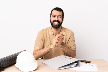 Wall Mural - Caucasian architect man with beard in a table applauding after presentation in a conference.