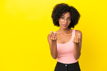 Wall Mural - Young African American woman isolated on yellow background making money gesture but is ruined