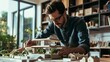 © WS Studio 1985 - handsome young architect looking at a scale model of a modern house in his office