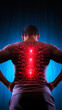 Muscular man standing turned and experiencing back pain in the form of redness on a dark background. Sports injury. Rehabilitation. Remedy ointment against pain. Spinal problems. Back exercises