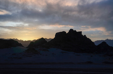 Wall Mural - peaks of mountains in the desert against sunset