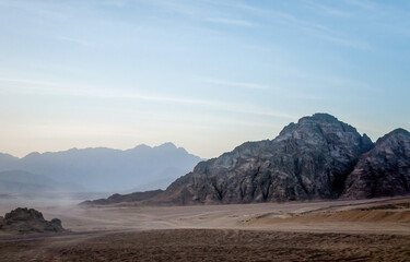 Wall Mural - desert with rocky mountains and sky with clouds in the evening in Egypt