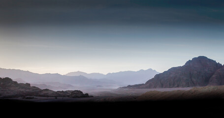 night desert landscape with rocky mountains and sunset sky with clouds in Sharm El Sheikh