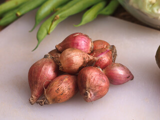 red onion with vegetables as a background, such as beans and cauliflower