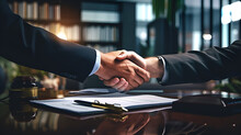 Two Partners Signing A Business Deal After A Successful Negotiation Doing A Handshake