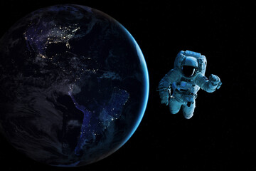 Wall Mural - cosmonaut is flying in outer space on night earth planet background. elements of this image furnishe