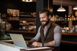 © ty - handsome businessman with a laptop at the counter bar