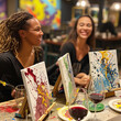 © Ryan - People having fun painting and sipping wine at a paint and sip event.