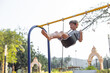 © Татьяна Волкова - Happy 6-7 year old boy is having fun, swinging high on swing on playground on summer day.