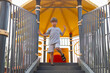© Татьяна Волкова - Cute boy in gray cotton T-shirt and shorts walks down stairs fromchildren's slide .