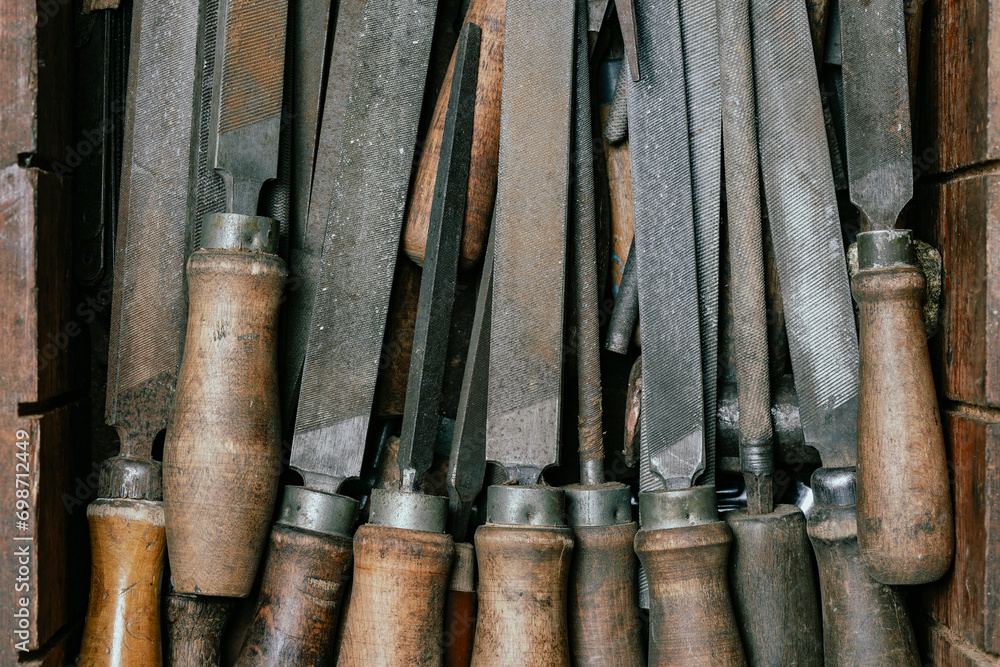 Old vintage rasps with wooden handles in wooden tool box . A set of ...