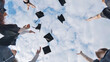 © Довидович Михаил - Happy college graduates tossing their caps up at sunset.