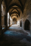 Fototapeta Uliczki - Interior corridor in ancient landmark building with gothic arch in a medieval architecture in Narbonne