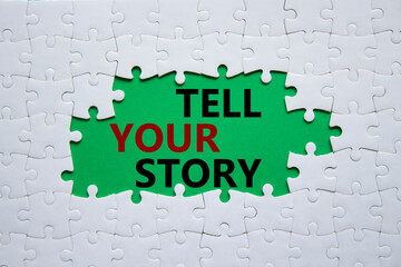 Tell your story symbol. Concept words Tell your story on white puzzle. Beautiful green background. Business and Tell your story concept. Copy space.