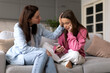 © Home-stock - Supportive mother comforting sad teen girl rejected by friends, helping depressed daughter to deal with breakup, child looking at phone