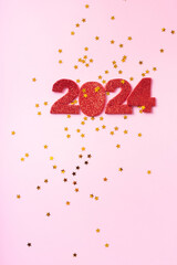 Wall Mural - Numbers 2024 and stars on a pink background. Happy new year concept