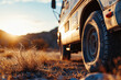 A truck parked in a field with the sun setting in the background. Suitable for various outdoor and transportation themes