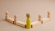 © photo for everything - wooden figure representing a leader leading other figures. Leadership concept