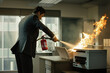 Fire in the office. A man in a suit is actively using a red fire extinguisher to put out flames on an office printer