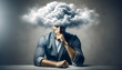 © Maule - Depressed businessman sitting at table with cloud above head.