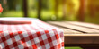 © Gabriela - table with checkered tablecloth, plate on blurred background