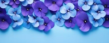 Frame Made Of Beautiful Violet And Purple Pansy Flowers On Light Blue Background With Copy Space. Floral Spring Backdrop. Border For Design Greeting Card Or Banner For Wedding, Mother Or Woman Day