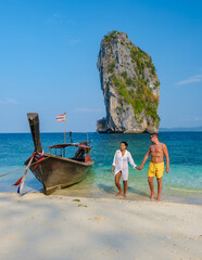 Wall Mural - Koh Poda Beach Krabi Thailand, the tropical beach of Koh Poda Island Krabi, a couple of men in swim short and women in bikini walking on the beach on a sunny day, 