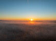 Aerial Elegance with a Blanket of Fog Settled Across the Plains, Embracing the Distant Sunset