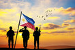 Silhouettes of soldiers with the Philippines flag stand against the background of a sunset or sunrise. Concept of national holidays. Commemoration Day.