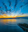 Aerial sunrise seascape with pretty cloud filled sky