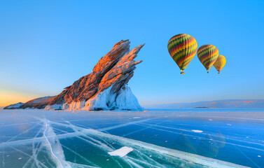 Wall Mural - Beautiful winter landscape of frozen Lake Baikal at sunrise - A granite rock with steep slopes rises above a frozen lake - Baikal lake, Siberia