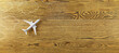 Creative white airplane and drawn clouds on wide wooden background with mock up place. 3D Rendering.