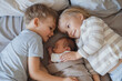 © Westend61 - Newborn baby boy sleeping near siblings lying in bed