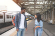 © Iryna - A Man and a woman are waiting for a train and arguing at a railway station platform toned image